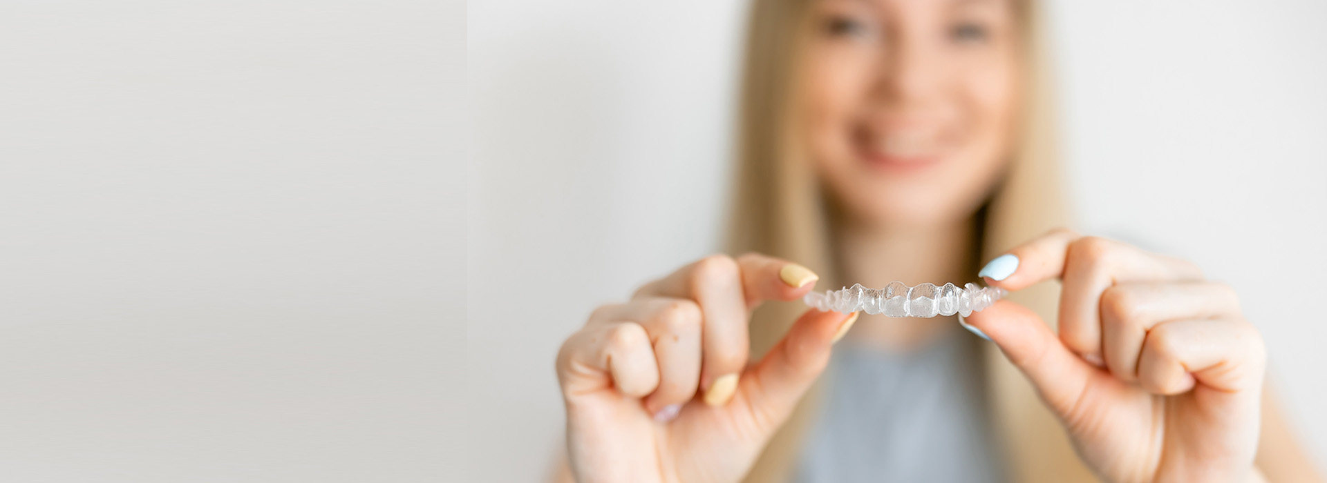 The image features a person s hand holding up a small object with text on it against a white background, possibly for promotional or informational purposes.