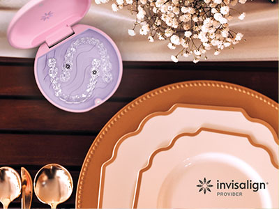The image shows a collection of tableware items, including plates, cups, and a box of dental floss, displayed on a wooden surface with a pink toothbrush and a blue toothpaste tube nearby.